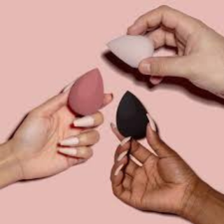 3 hands holding makeup sponges