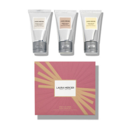 Three silver tubes of Laura Mercier cream with a pink box featuring the brand logo on a white background.
