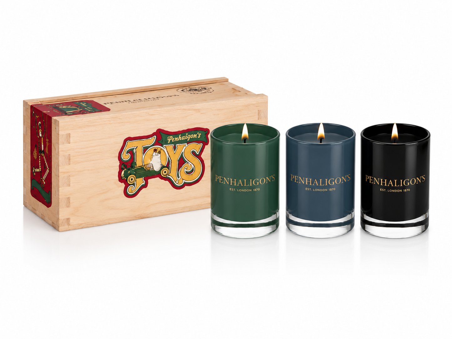 Three Penhaligon's candles in a wooden box with 'Toys' branding on a white background