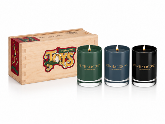 Three Penhaligon's candles in a wooden box with 'Toys' branding on a white background